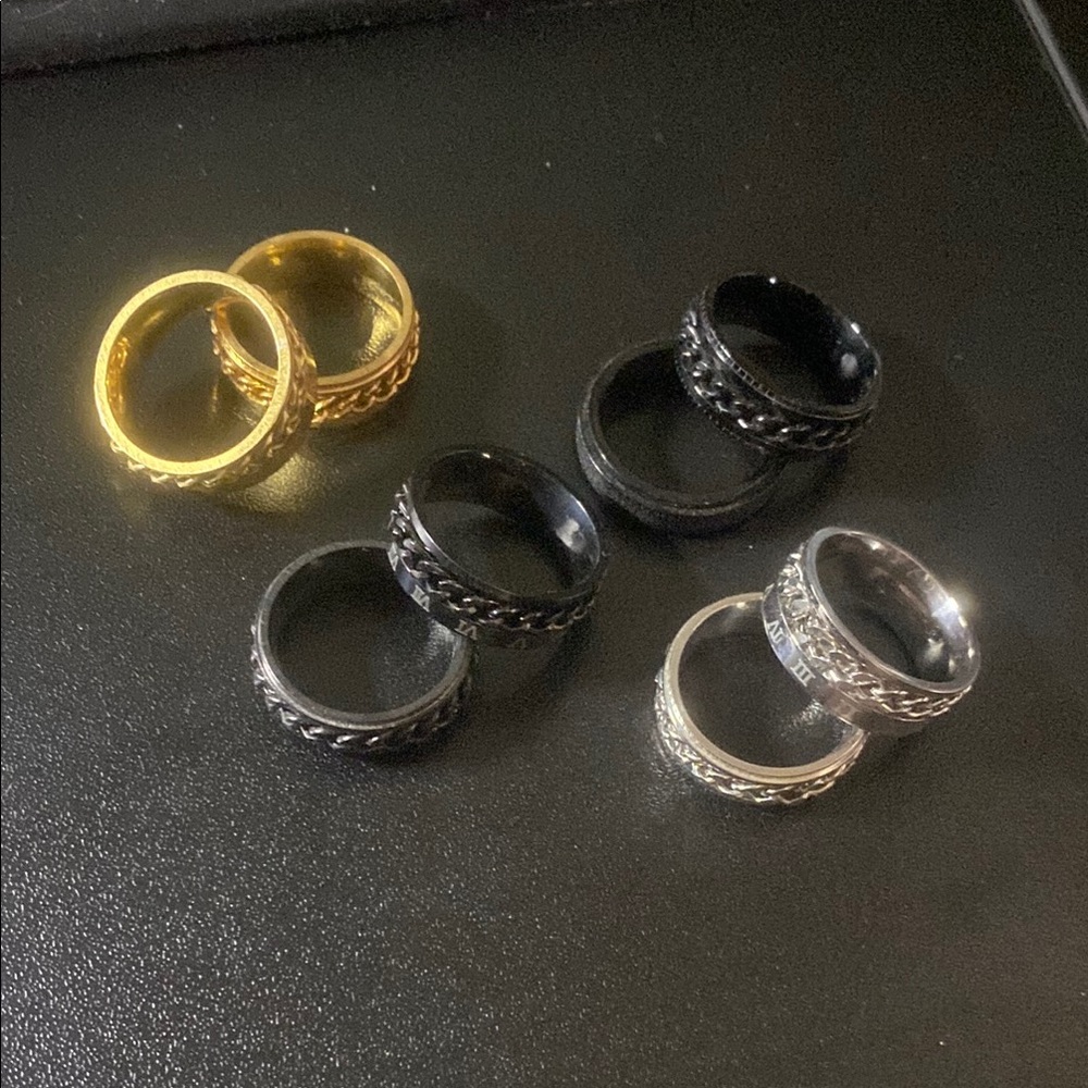 Set of Gold, Black, and Silver Chain Rings